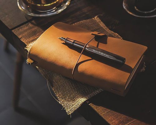Details of an office desk with a notebook