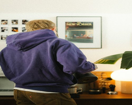 Person standing near a desk at home