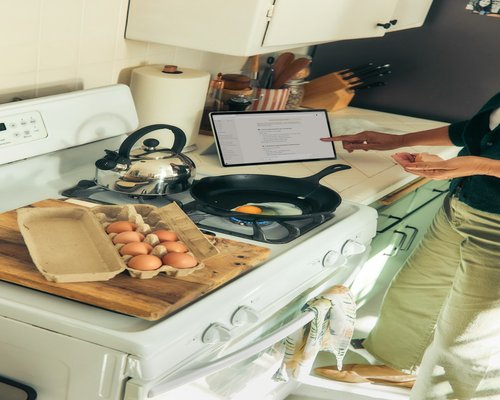 Person preparing breakfast calmly in a well-lit kitchen